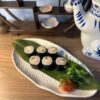 Artful presentation of Maki Crab sushi in Edinburgh, served on a leaf on an elegant white plate.