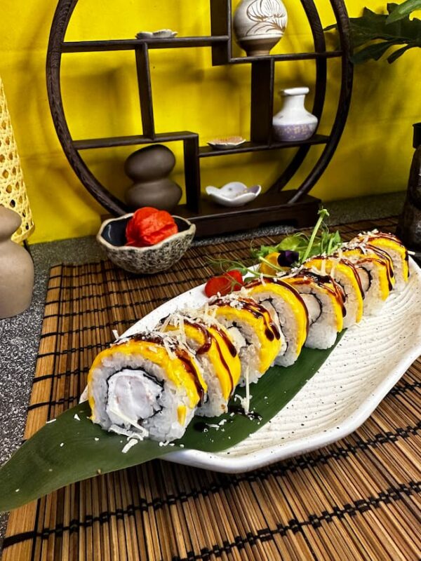 Cheese Roll with Shrimp topped with melted Parmesan and Unagi sauce, a gourmet sushi dish from Edinburgh