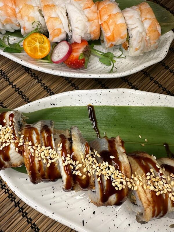 Close-up of a Philadelphia with Eel sushi roll, showcasing the eel's rich texture and sesame seed topping, served in Edinburgh