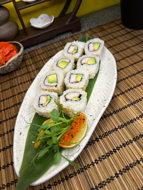 Crab Avocado Roll sushi elegantly presented with vibrant green avocado and tobiko garnish, a culinary delight from an Edinburgh sushi spot