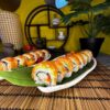 Ebi Phila sushi, featuring shrimp and avocado, served on a leaf plate with a minimalist backdrop, a culinary delight in Edinburgh