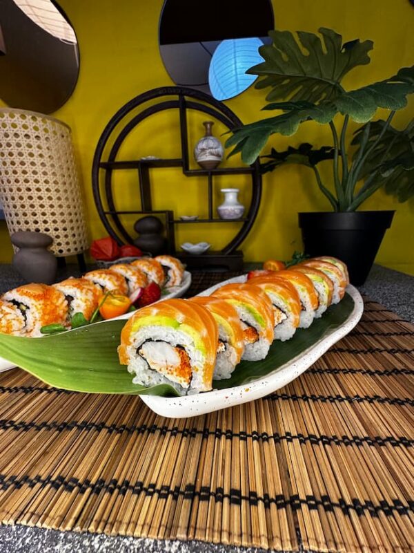 Ebi Phila sushi, featuring shrimp and avocado, served on a leaf plate with a minimalist backdrop, a culinary delight in Edinburgh