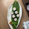 Edinburgh Maki Crab delicacy presented on a leaf over a stylish plate, Japanese pottery beside