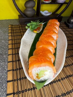 Edinburgh's exquisite Signature Minami sushi roll, showcasing a generous topping of salmon and a sprinkle of tobiko caviar for a burst of flavor