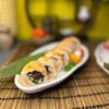 Elegant California Classic Tobiko sushi garnished with flying fish roe on a leaf plate, showcasing Edinburgh's culinary finesse