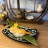 Elegant Nigiri Shrimp on a decorative black plate, perfect for a sushi snack in Edinburgh.