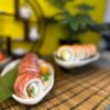 Elegant Philadelphia with Tuna sushi roll adorned with fresh garnishes on a simple backdrop, showcasing Edinburgh's fine sushi