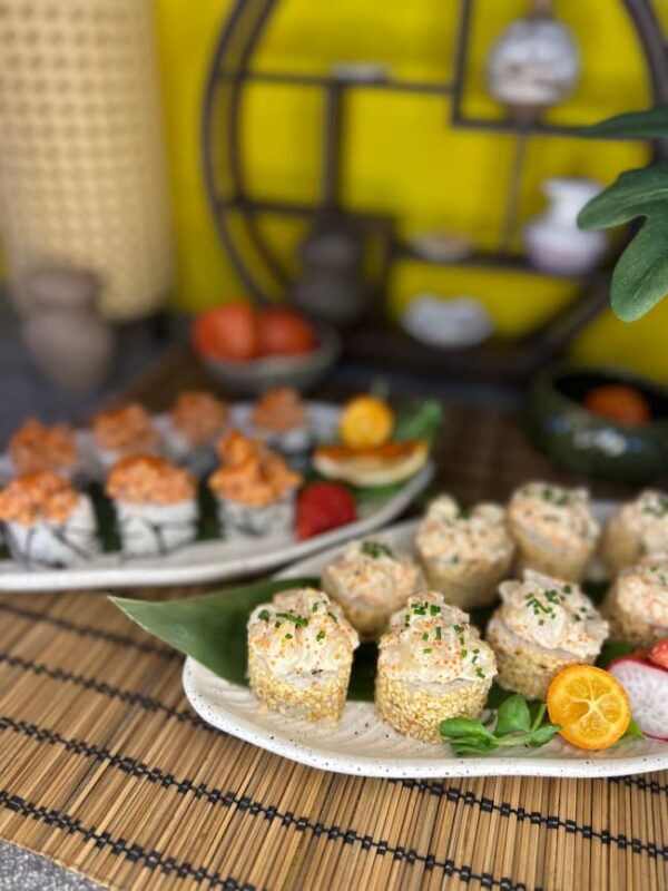 Elegant Tartarus with Sea Scallop sushi rolls coated with sesame seeds, nestled among fresh garnishes, available in Edinburgh