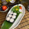 Elegant presentation of Maki Shrimp sushi rolls accompanied by a fresh garden salad, a classic choice in Edinburgh's sushi cuisine