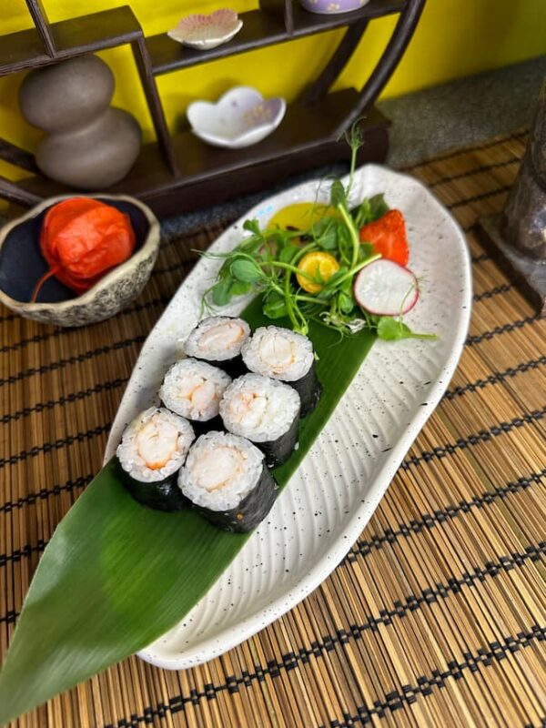 Elegant presentation of Maki Shrimp sushi rolls accompanied by a fresh garden salad, a classic choice in Edinburgh's sushi cuisine