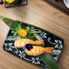 Exquisite Nigiri Shrimp on a leaf, with vibrant garnish, a delicious sushi treat in Edinburgh.