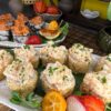 Gourmet Tartarus with Sea Scallop sushi garnished with sesame seeds, served with fresh fruits on a traditional bamboo mat in Edinburgh