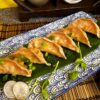 Gyoza Prawn arranged on a leaf on a decorative blue plate, a taste of Edinburgh