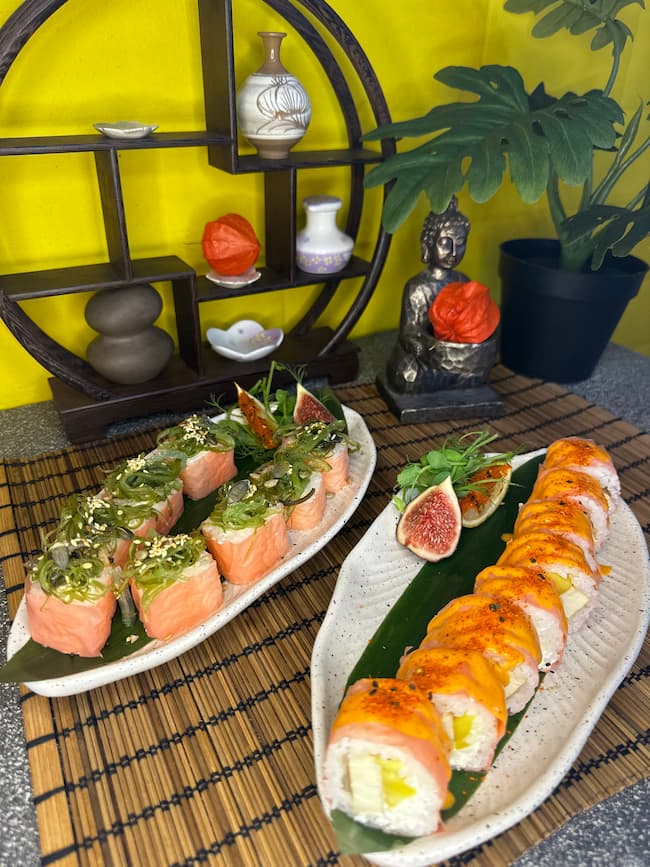 Assorted gourmet vegan sushi rolls adorned with avocado, sesame seeds, and fresh figs, showcasing the artistry of Minami Sushi's plant-based options in Edinburgh.