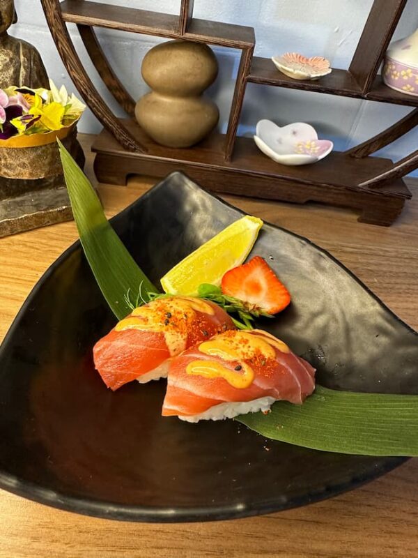 Luxurious Nigiri Tuna with spicy sauce garnish, a premium sushi snack in Edinburgh