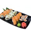 Salmon Lover Sushi set featuring sushi rolls, nigiri, wasabi, and pickled ginger on a black plate against a white background.