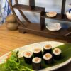 Overhead view of Maki Salmon rolls, a classic Edinburgh sushi snack on a textured plate