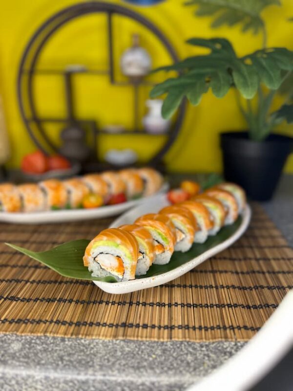 Phila Ebi sushi roll with shrimp, cream cheese, and avocado, a 280g treat set against a vibrant yellow backdrop in an Edinburgh sushi spot