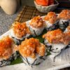 Spicy Tuna Tartarus sushi with fiery sauce and tobiko on a bed of rice, an Edinburgh sushi specialty