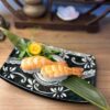 Succulent prawn nigiri served as a refined snack on a beautifully patterned plate in Edinburgh.