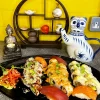 Assorted California Sushi Platter on black plate, featuring nigiri and sesame rolls in Edinburgh