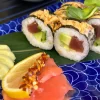 Close-up of Futomaki tuna sushi, highlighting the rich texture of tuna, avocado, and cucumber with spicy sauce in Edinburgh.