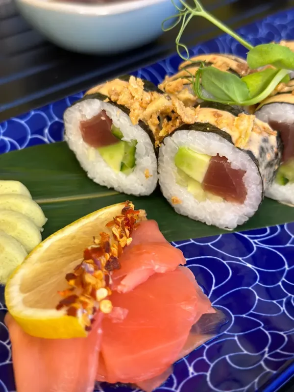 Close-up of Futomaki tuna sushi, highlighting the rich texture of tuna, avocado, and cucumber with spicy sauce in Edinburgh.