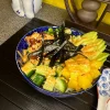 Close-up of Tuna Poke bowl showcasing tuna and mango