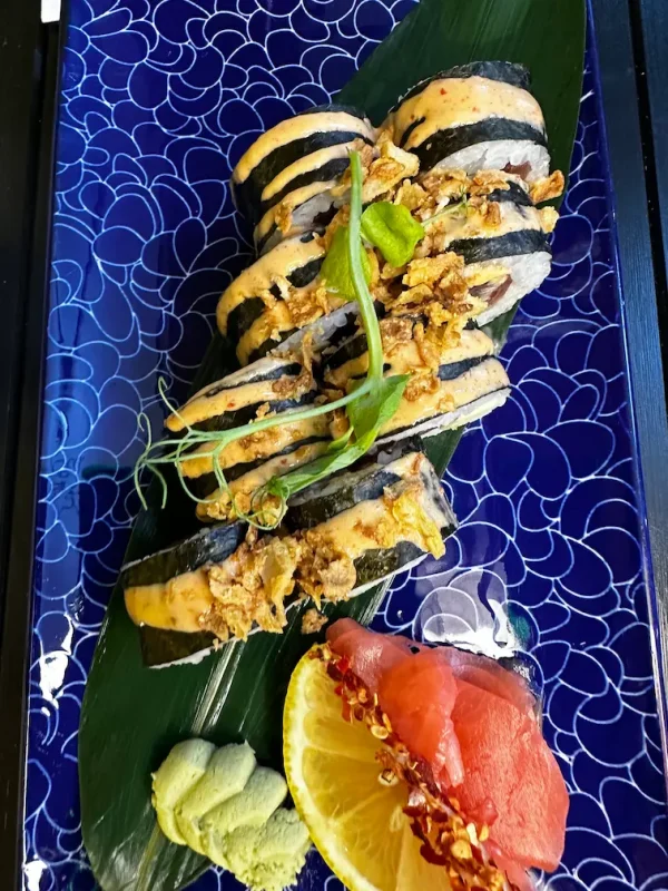 Complete serving of Futomaki tuna on a traditional Japanese leaf, featuring nori, rice, and spicy toppings in Edinburgh