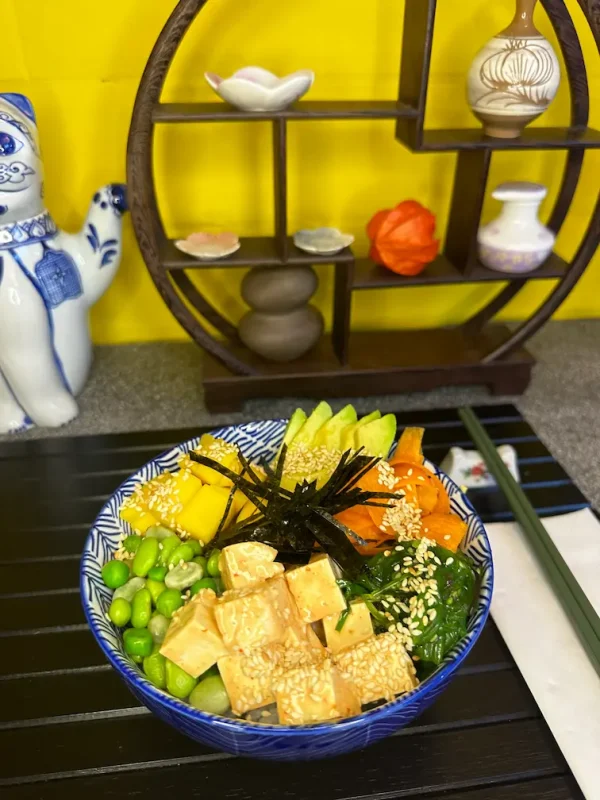 Healthy Vegan Poke bowl loaded with fresh vegetables, chilled noodles, and nut sauce, offering a vibrant, nutritious meal option in Edinburgh