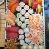 The Imperial feast set features nigiri, sashimi, maki rolls, and crab salad on a rectangular white plate.
