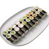 Maki set: A white plate with three rows of assorted vegetable and fish sushi rolls on a white background.