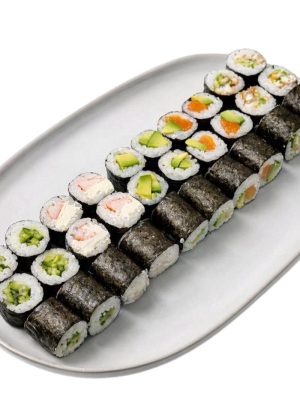Maki set: A white plate with three rows of assorted vegetable and fish sushi rolls on a white background.