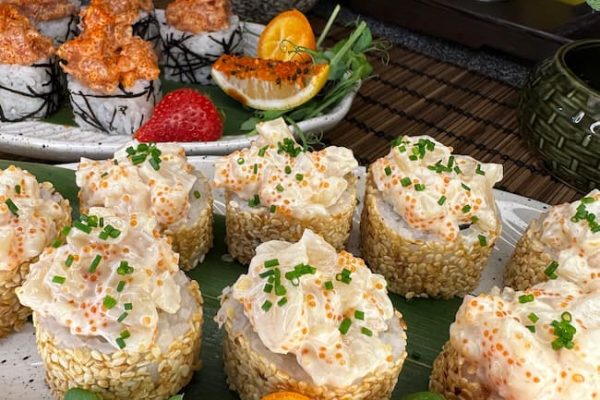 Gourmet Tartarus with Sea Scallop sushi garnished with sesame seeds, served with fresh fruits on a traditional bamboo mat in Edinburgh Gourmet Tartarus with Sea Scallop sushi garnished with sesame seeds, served with fresh fruits on a traditional bamboo mat in Edinburgh